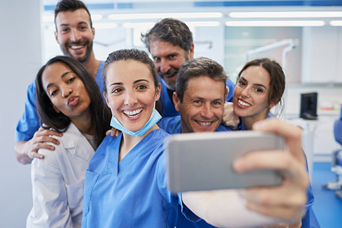 dentist and dental staff pose for a selfie